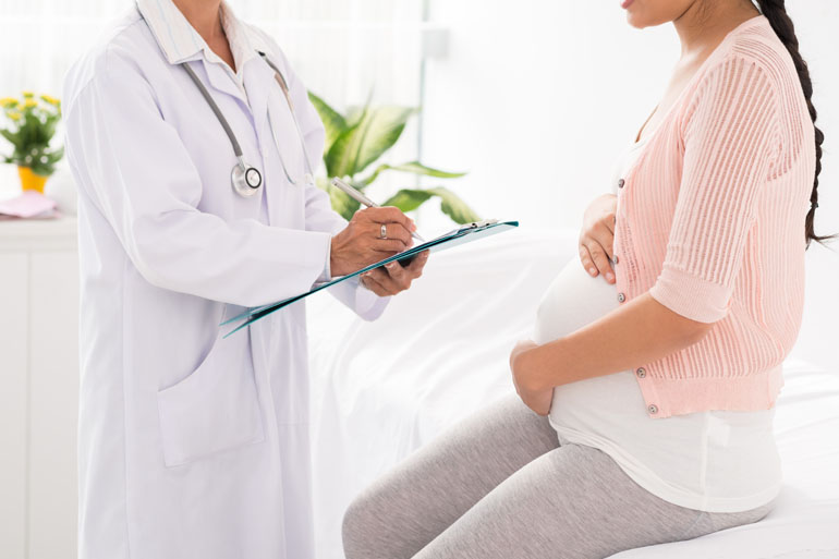Cropped image of pregnant woman visiting doctor
