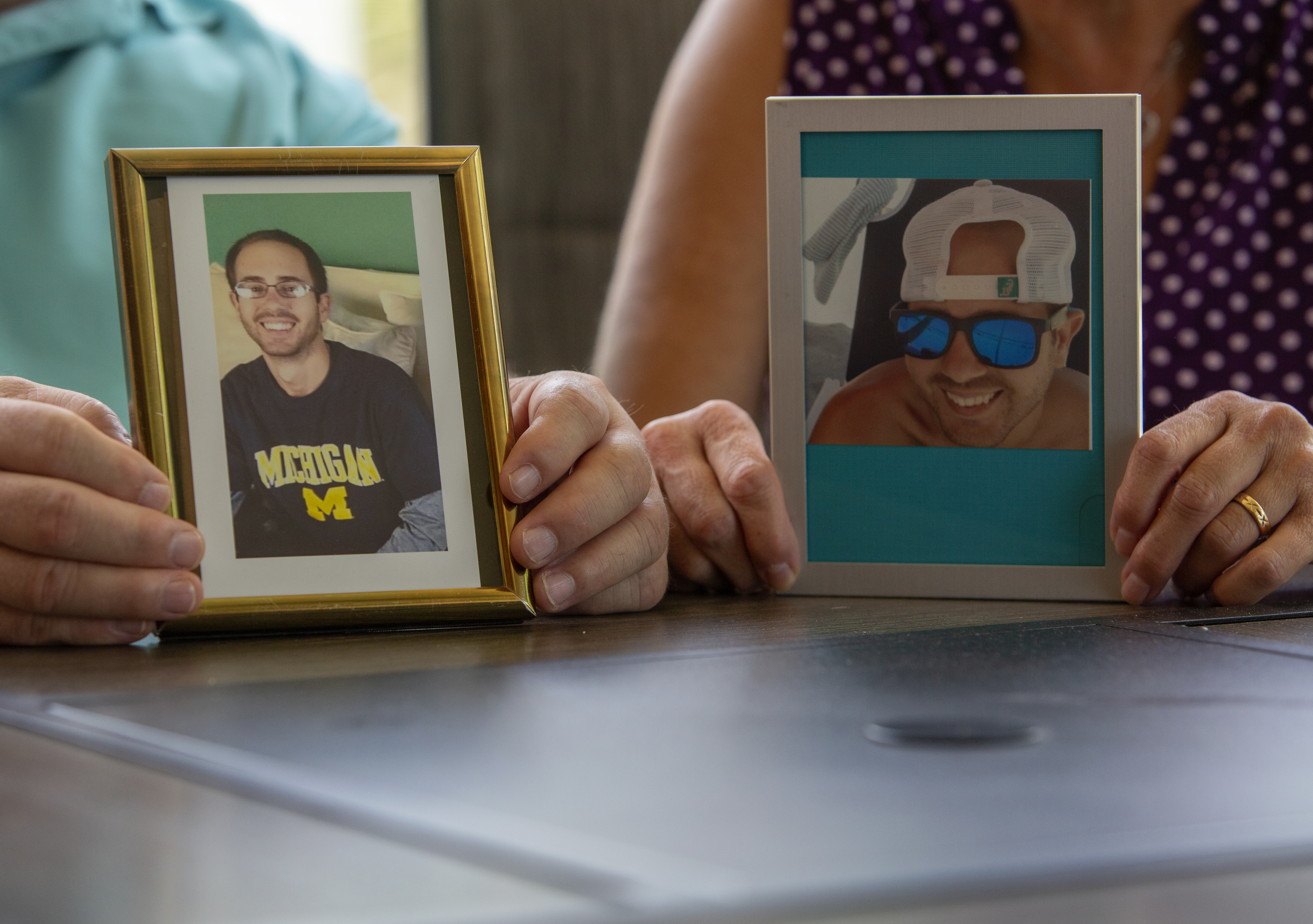 Jim and Suzanne Rybak hold photos of their son Jameson who died of an overdose in 2020.