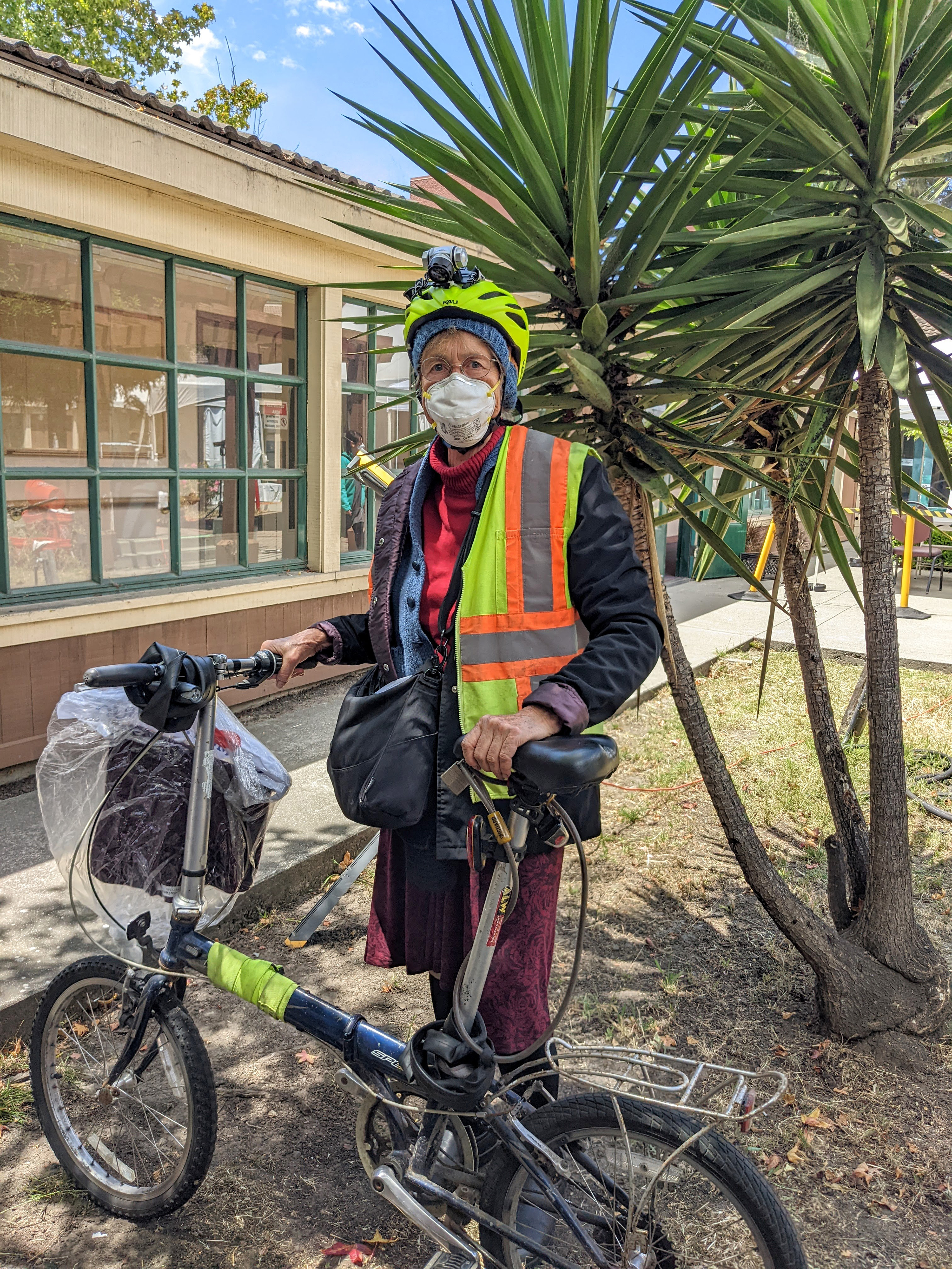 Mary White is seen posing for a photo with her bicycle.