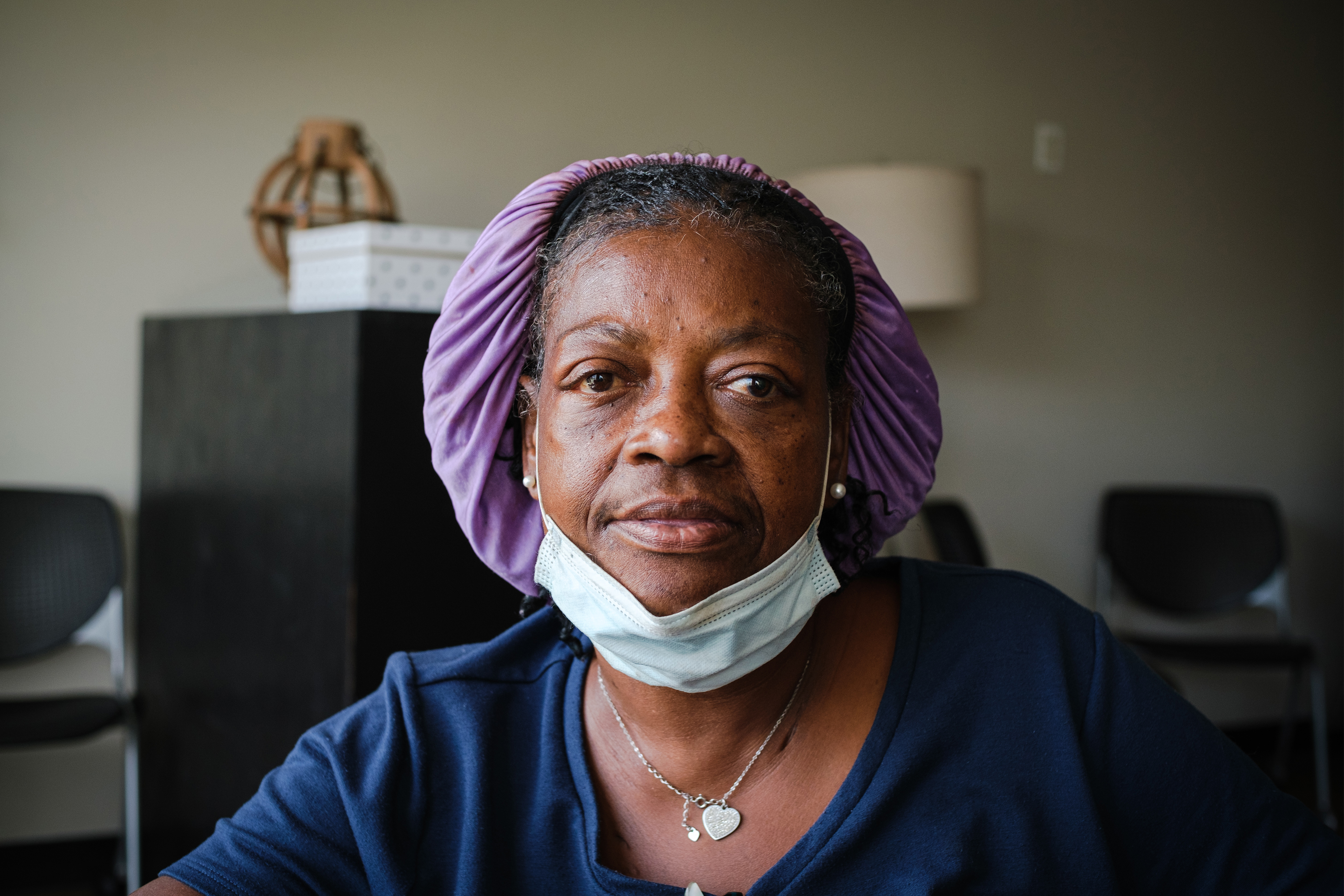 A photo shows Margaret Davis posing for a portrait. She is lit from the left by a window.