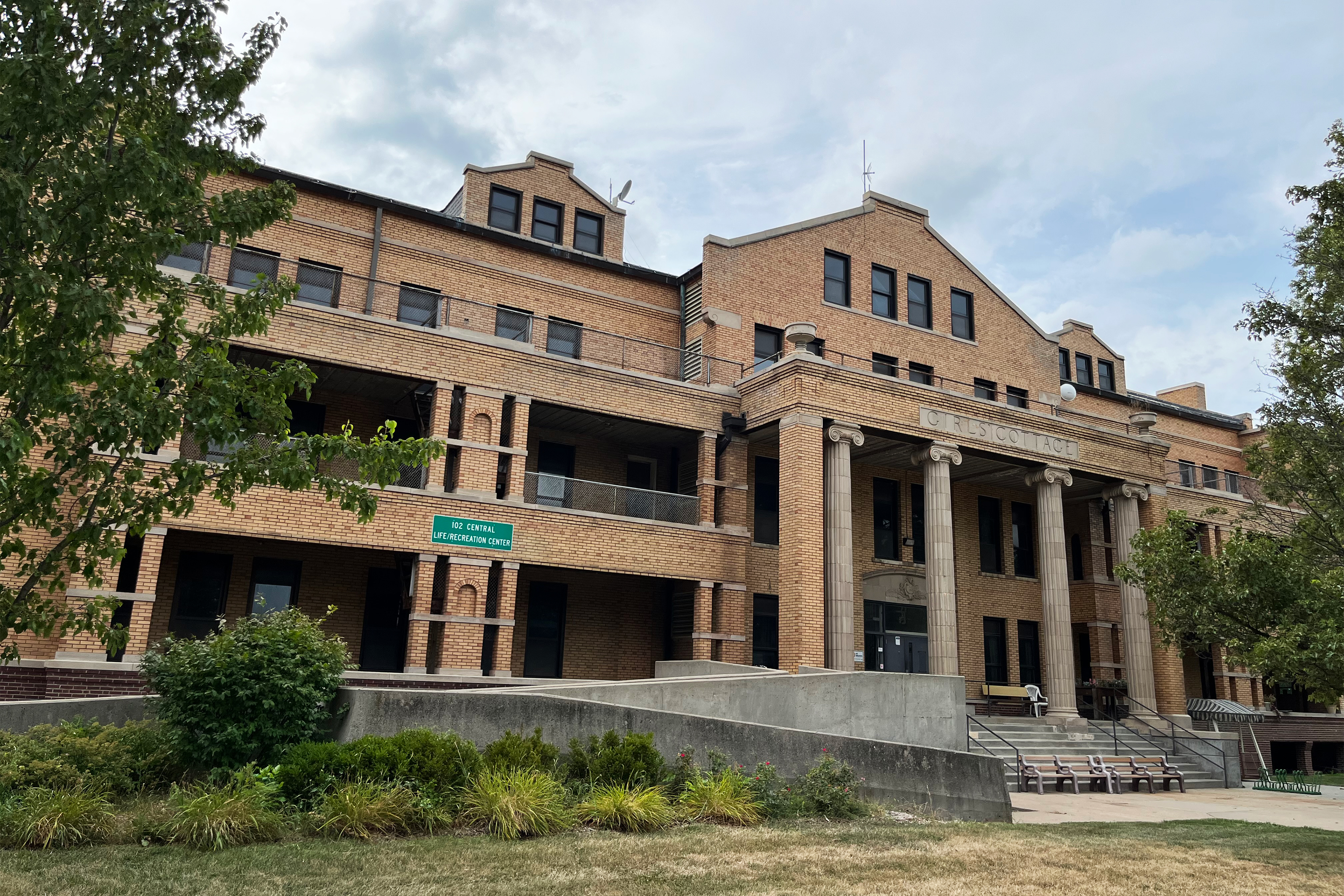 A photo shows one of Glenwood Resource Center's older buildings. It is a large brick building labelled, "Girls' Cottage."