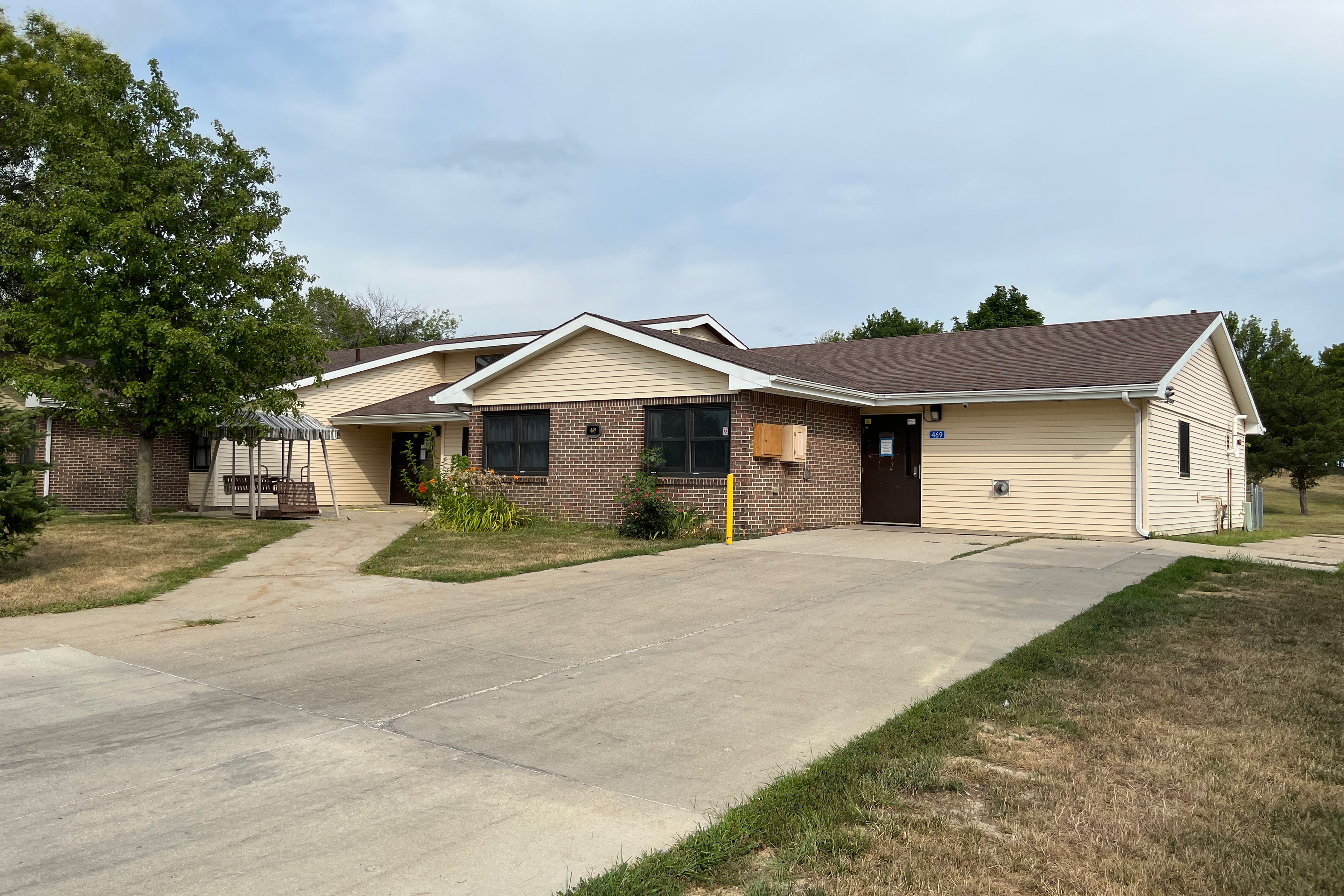 A photo shows a one-story house with a large concrete driveway.