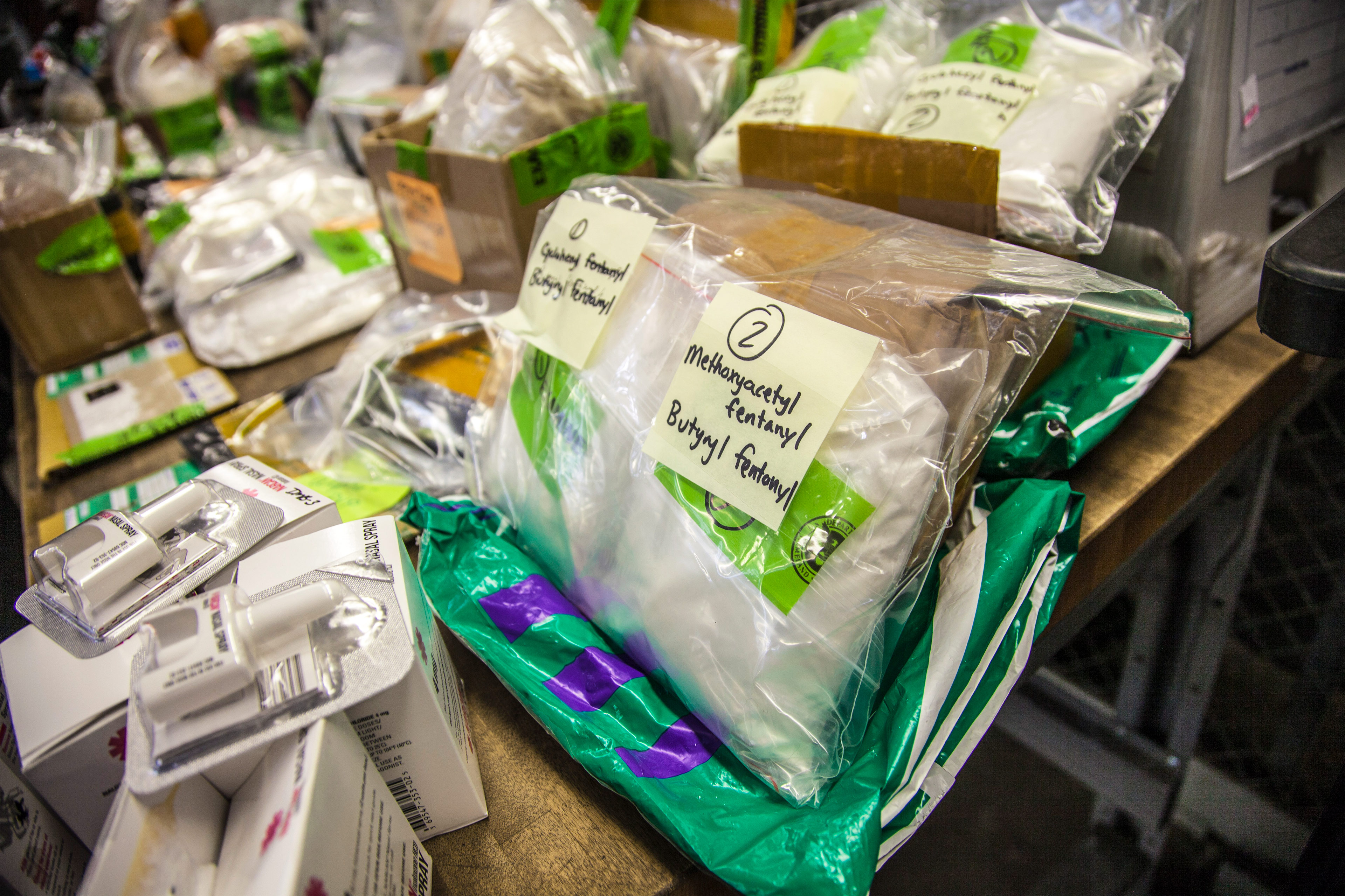 A photo shows a package of fentanyl and the overdose-reversing drug Narcan on a table.