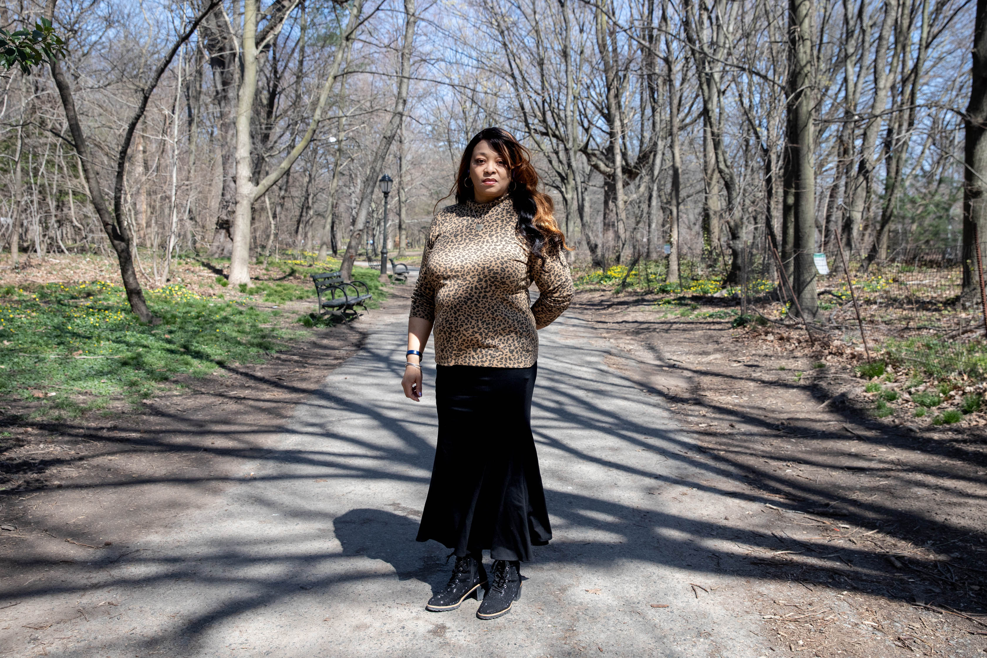 A photo of a woman standing outside at a park.