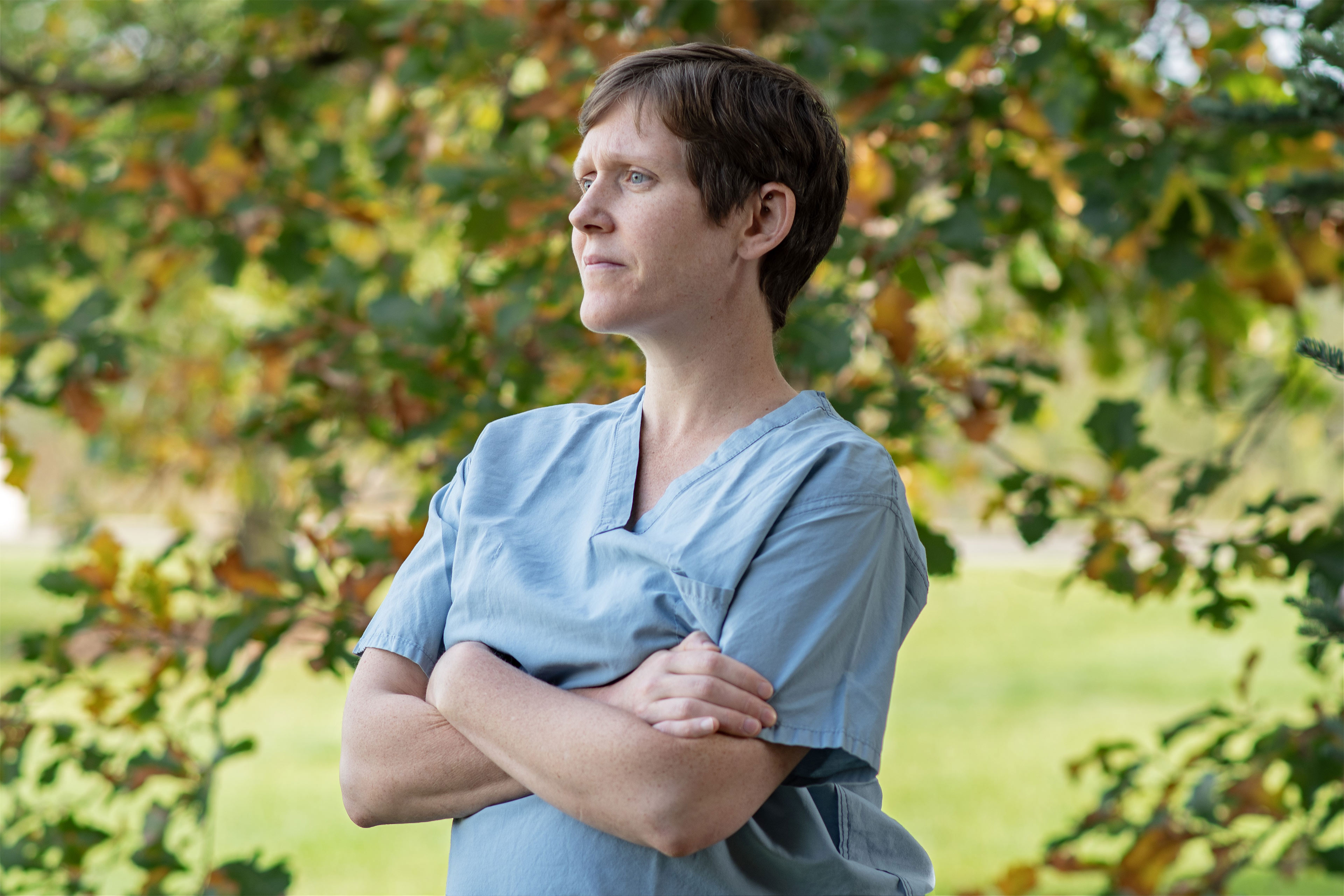 A photo of an OB-GYN posing for a portrait outside.