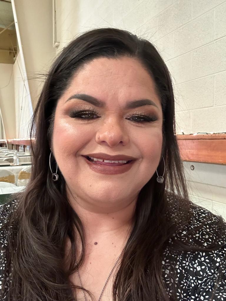 A selfie of a woman with long brown hair.