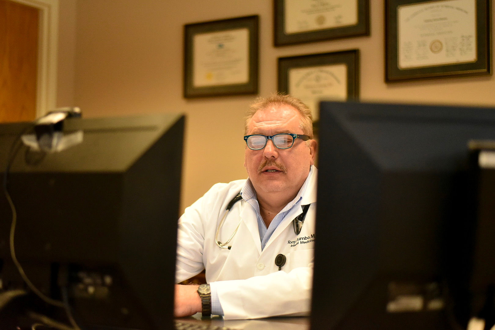 A photo of Stumbo sitting at a desk and using the computer.