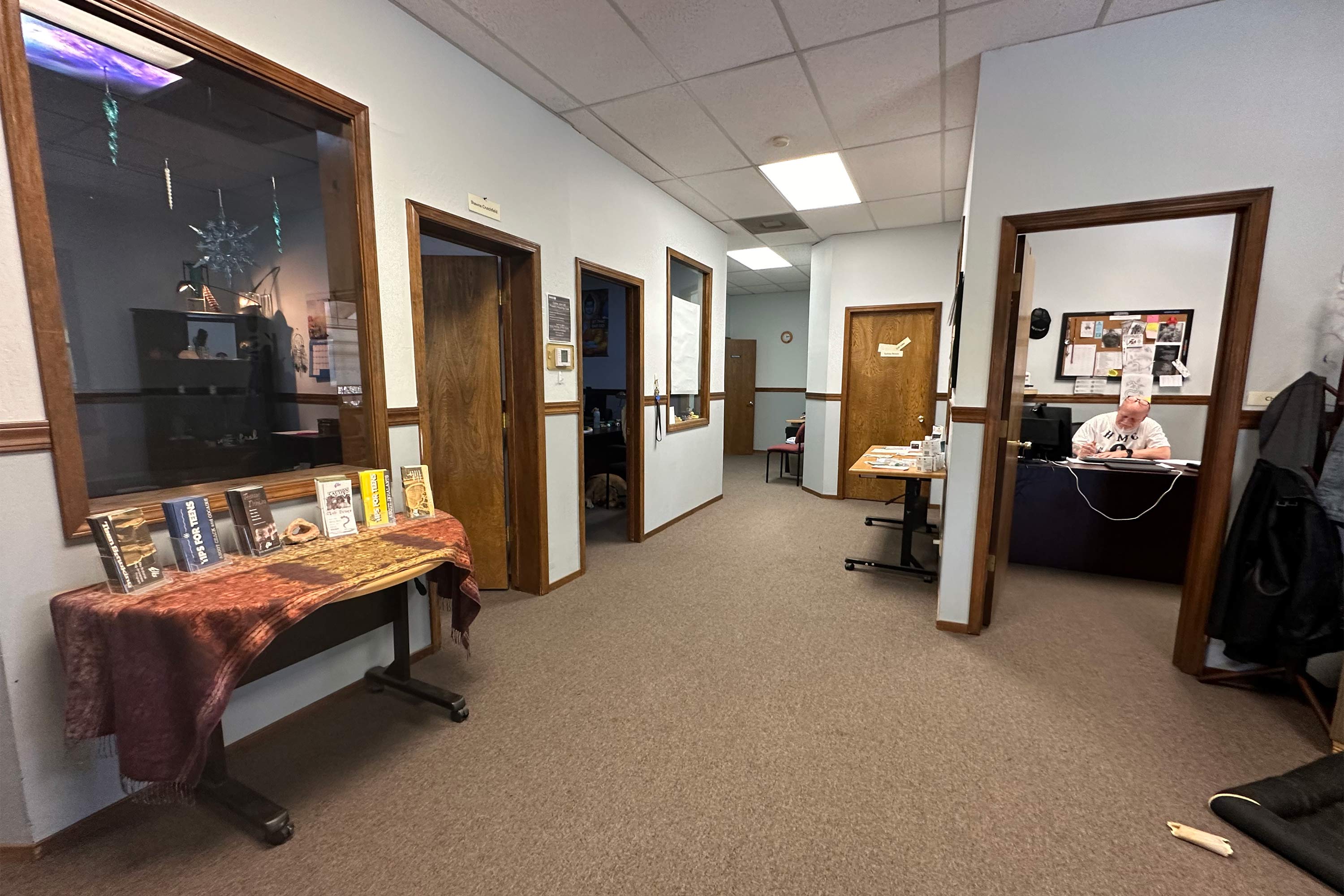 A photo of an interior with offices and a table with pamphlets.
