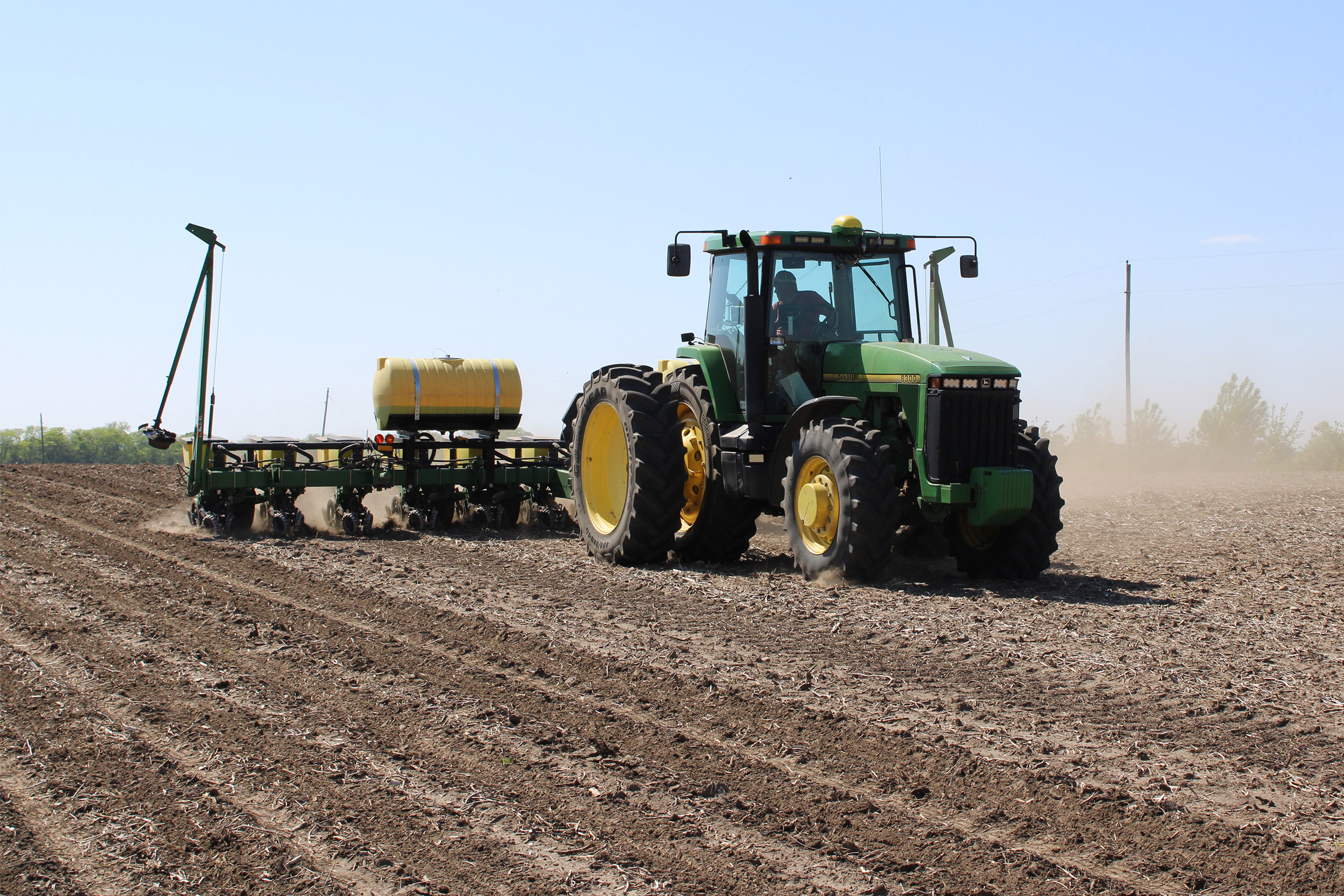 A photo of a tractor rolling across a field.