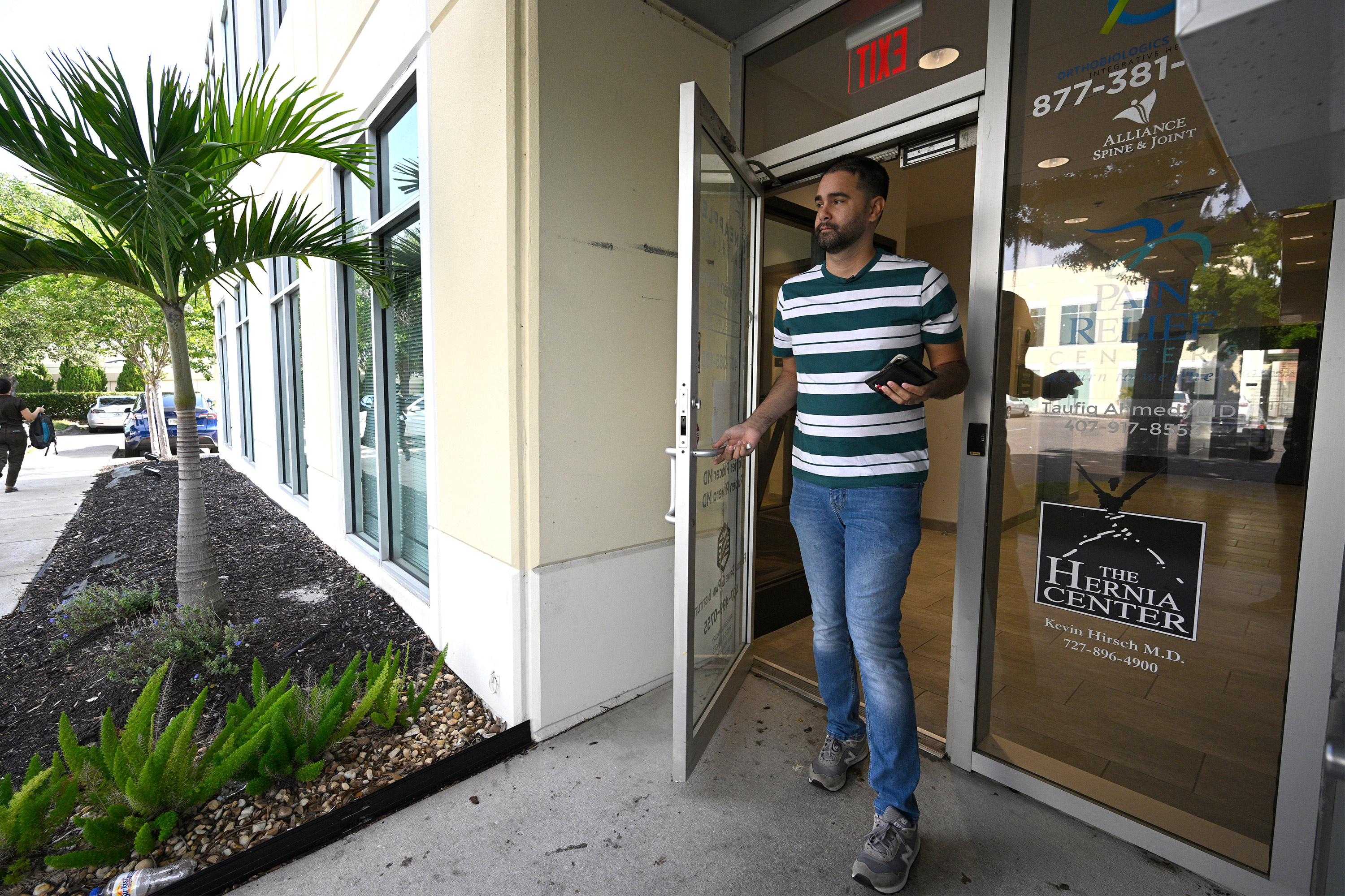 A photo of a man leaving a health clinic.