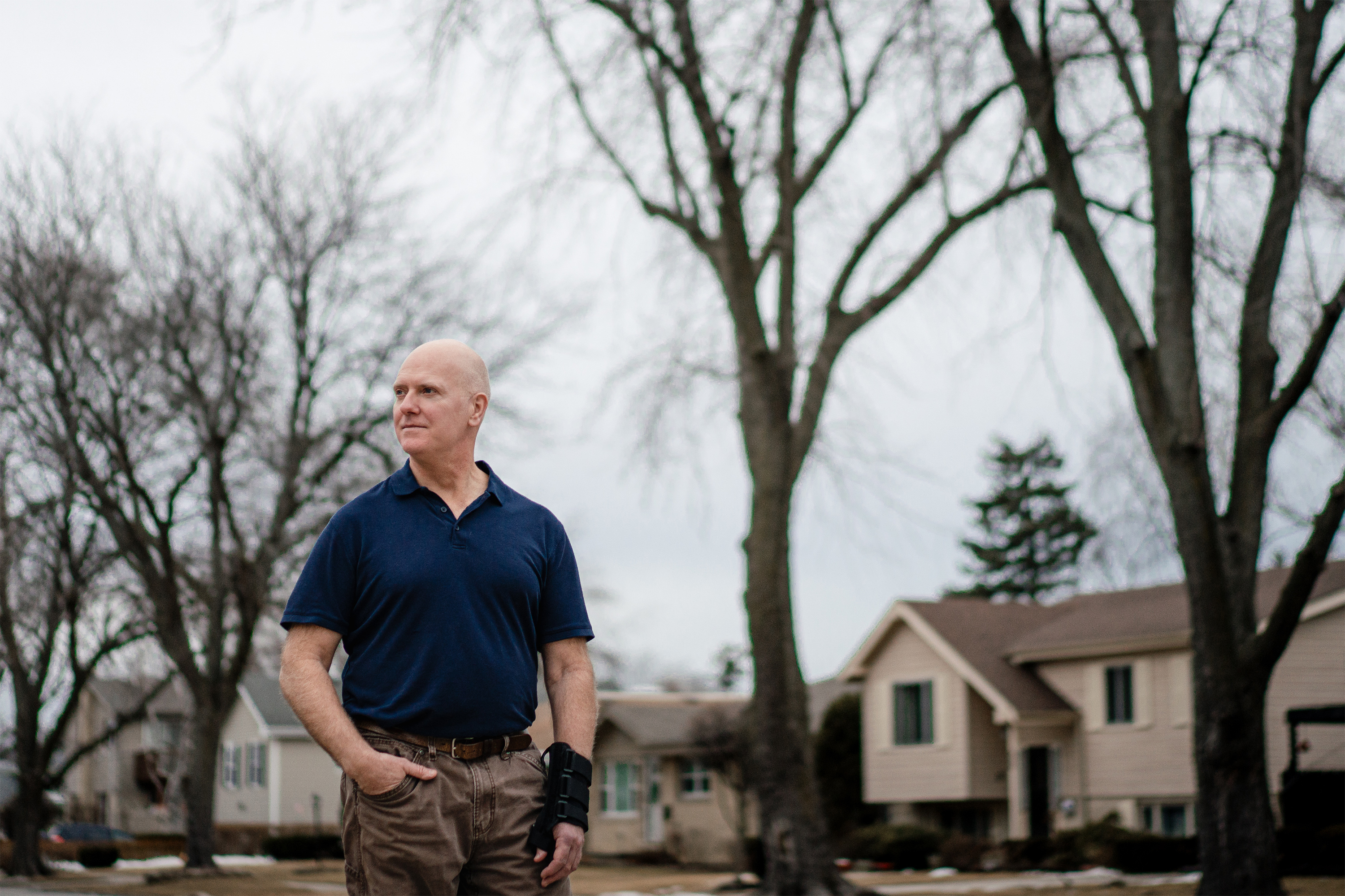 A photo of Tim Winard posing for a portrait outside his home.