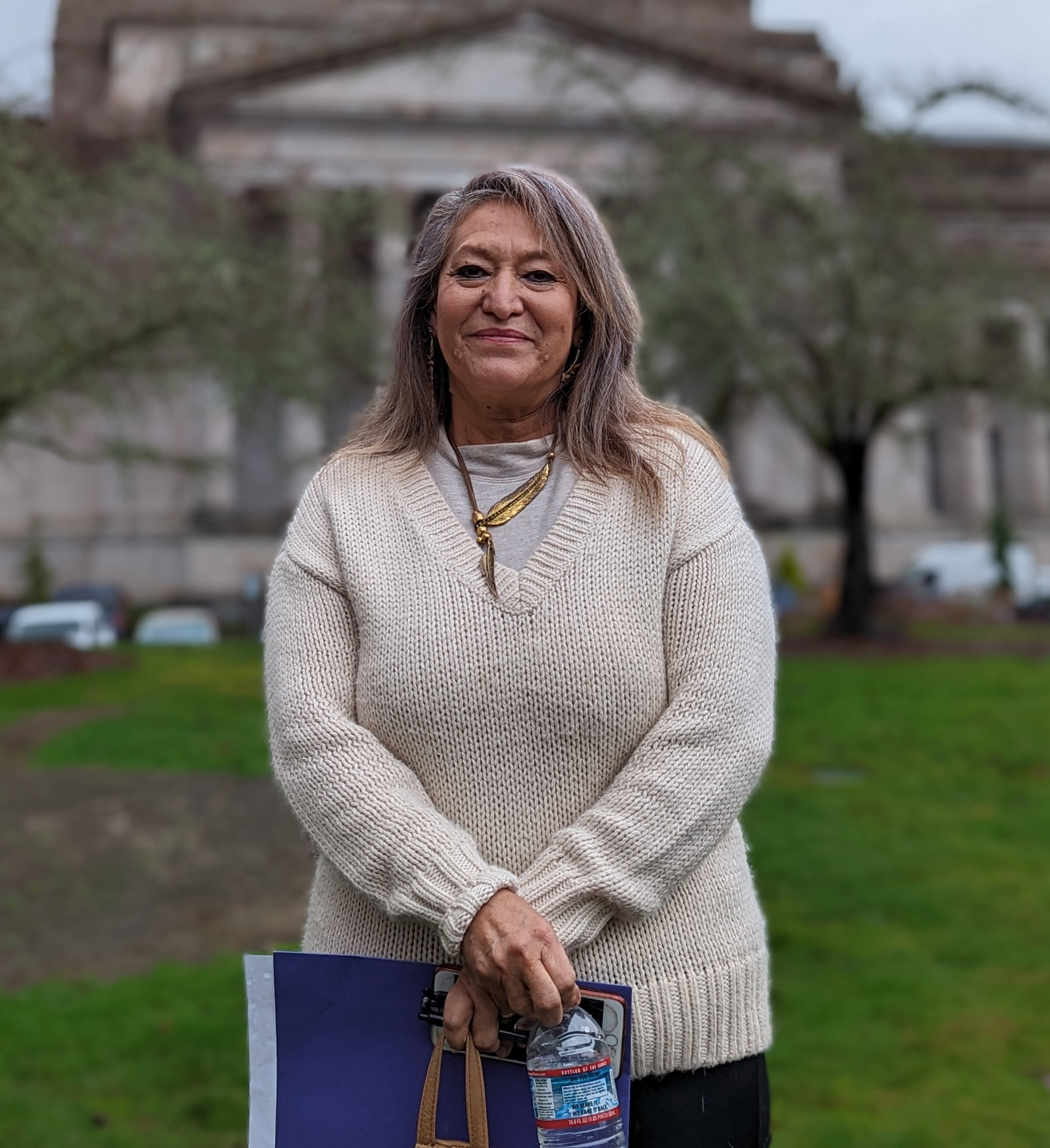 A photo of a woman standing for a portrait outside.