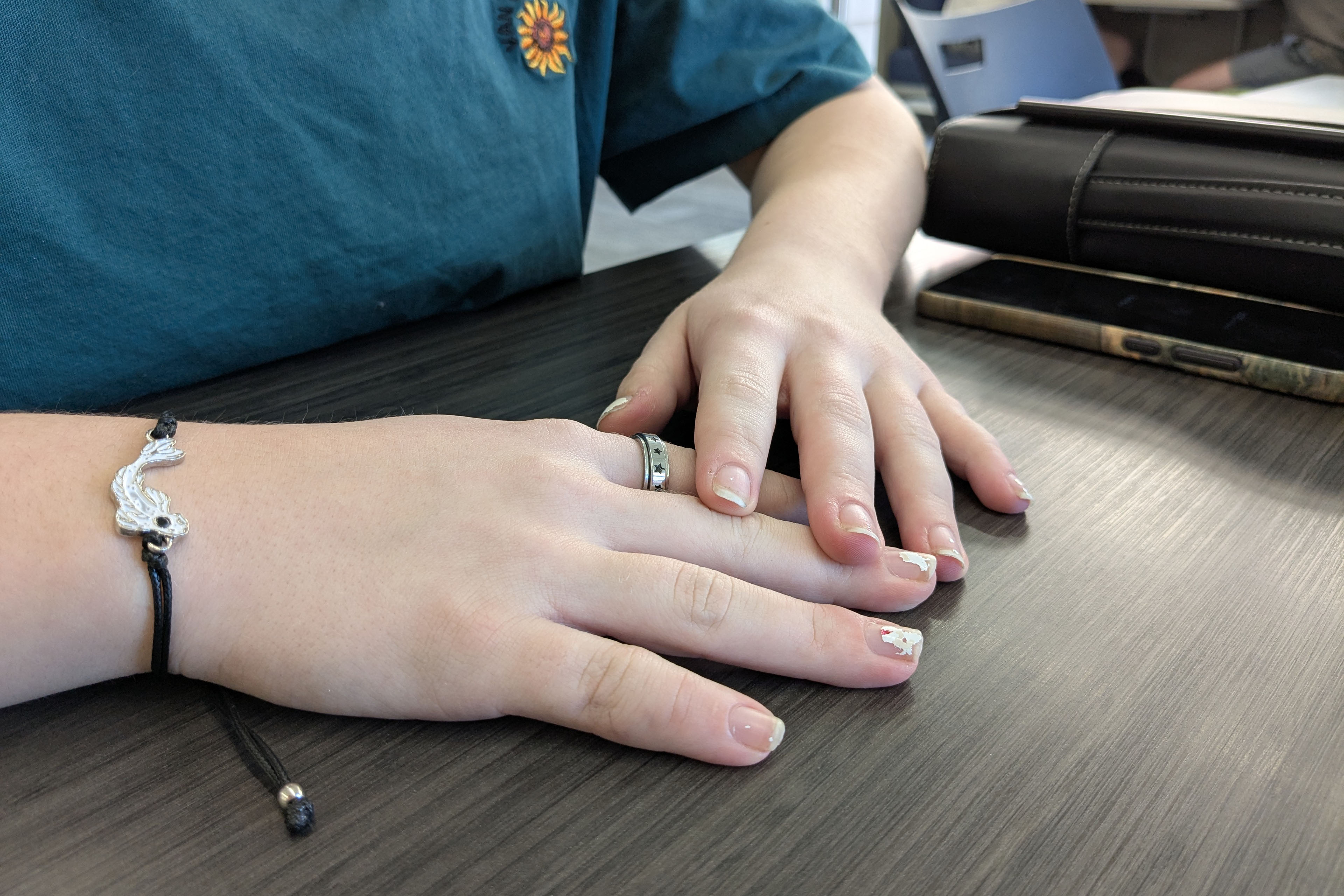 A tightly cropped photograph of a teenager's hands.