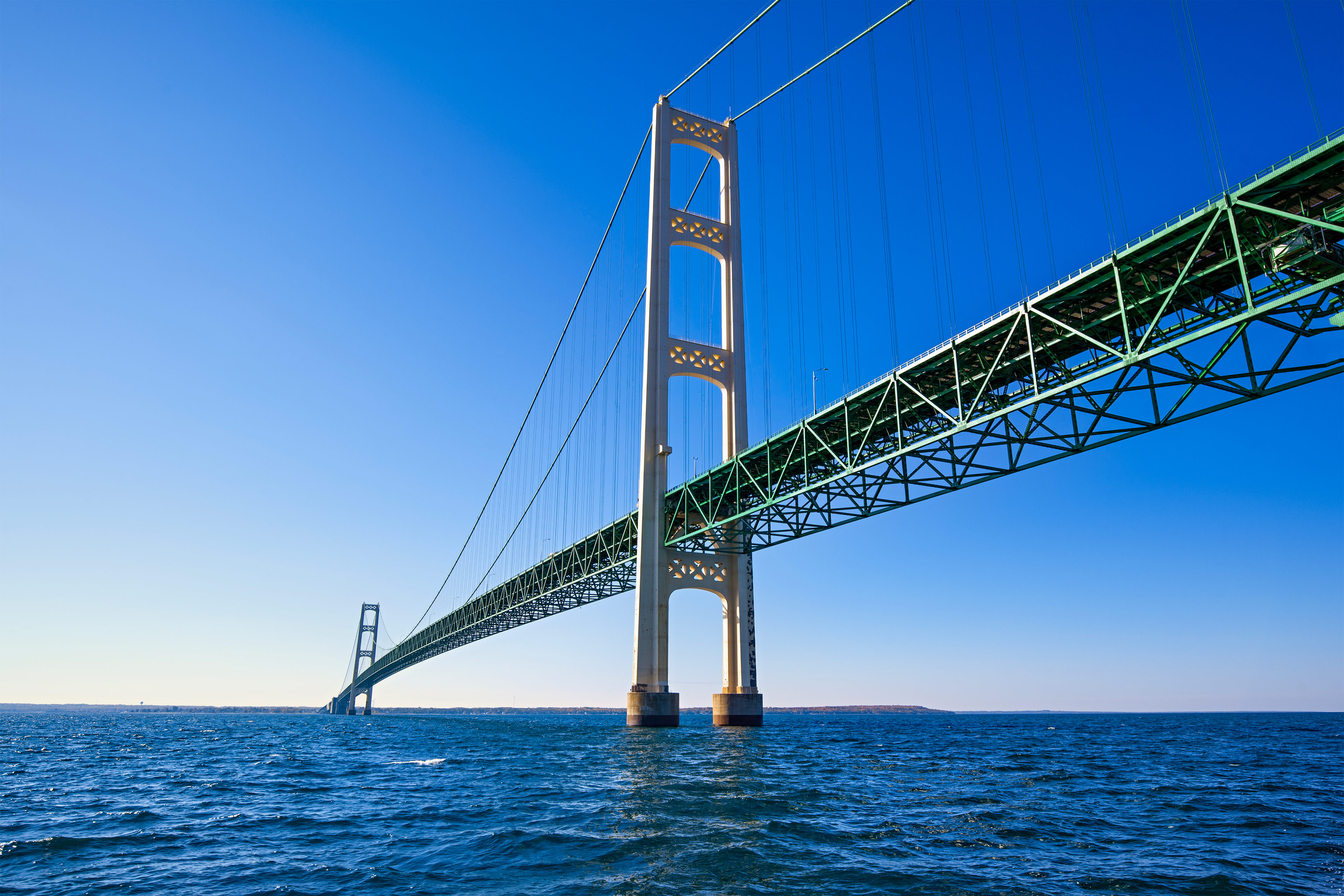 A photo of a long bridge stretching across open water.