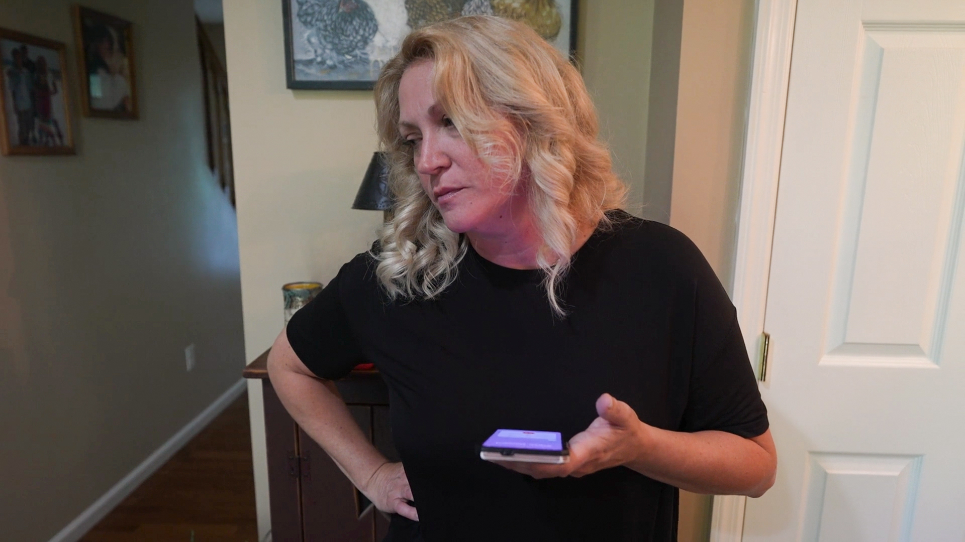 A photo of Rebecca Tennant making a phone call.