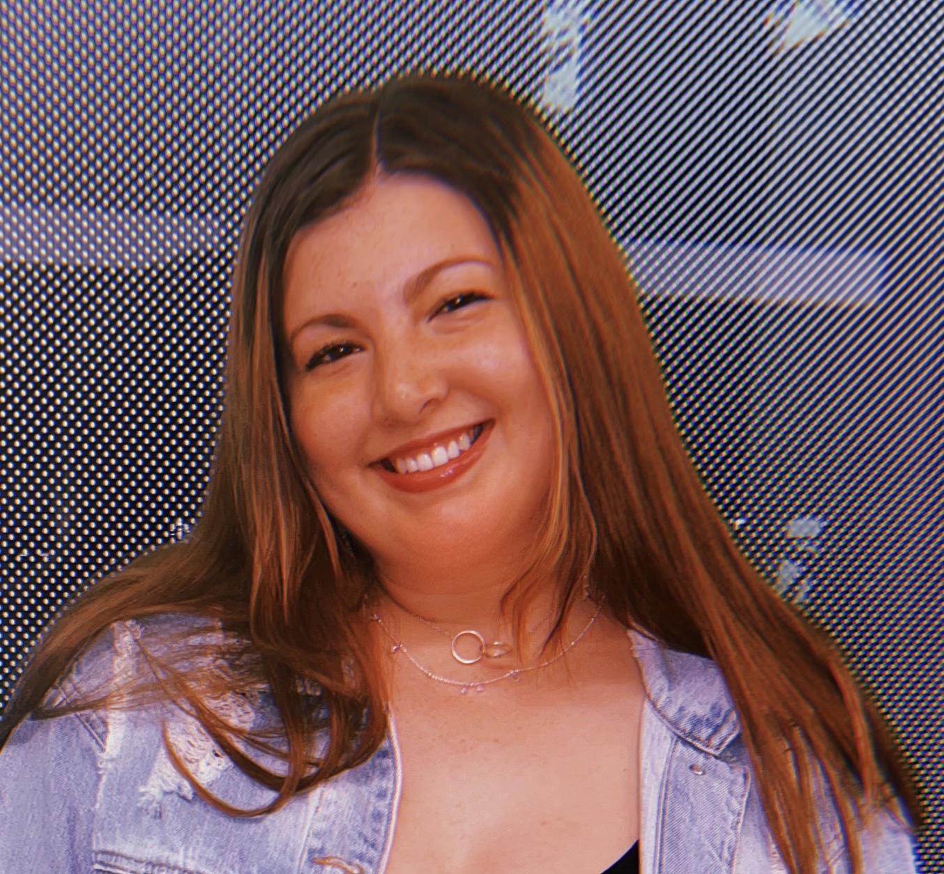 A photo of a woman smiling outside.