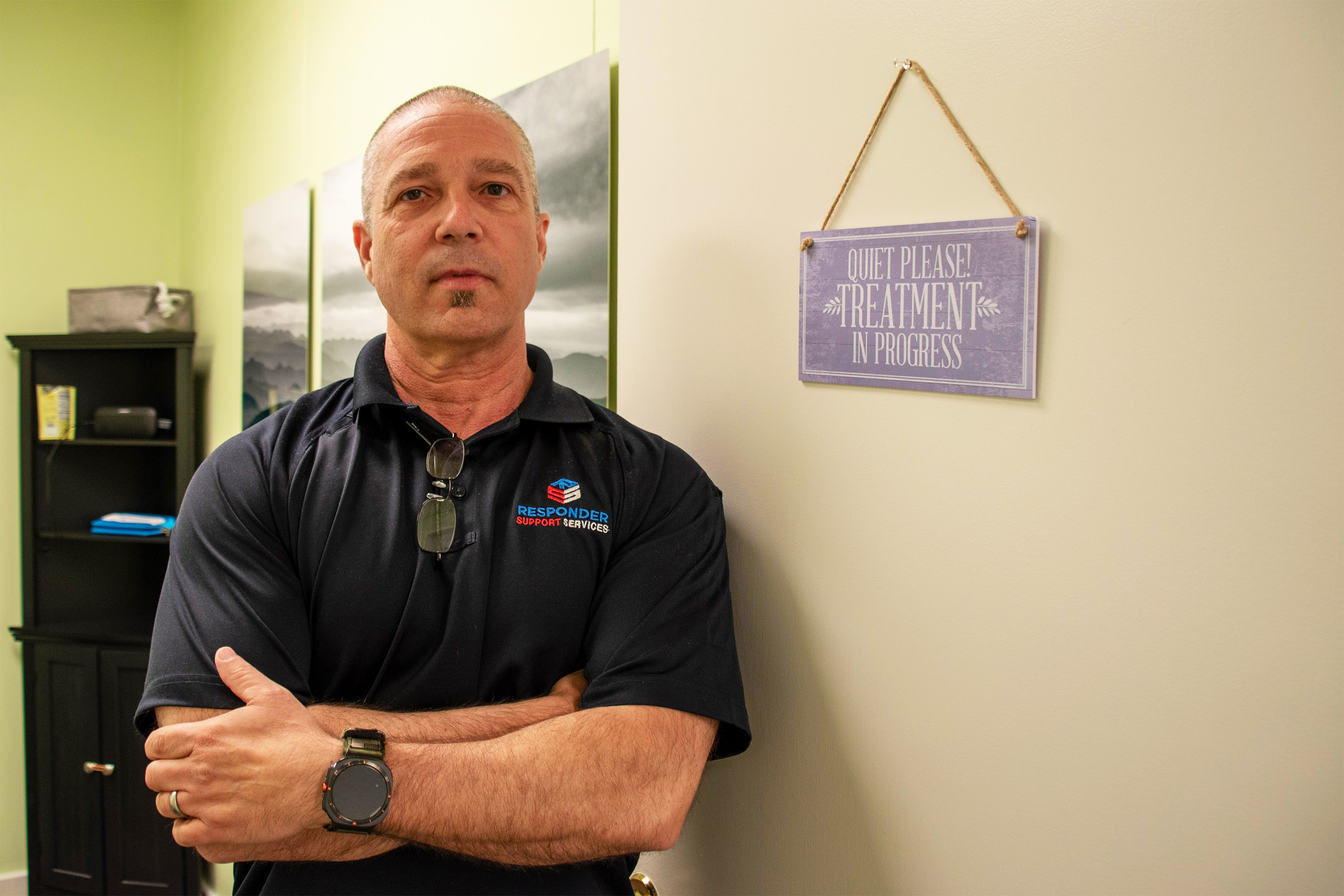 A photo of a man standing in a doorway.