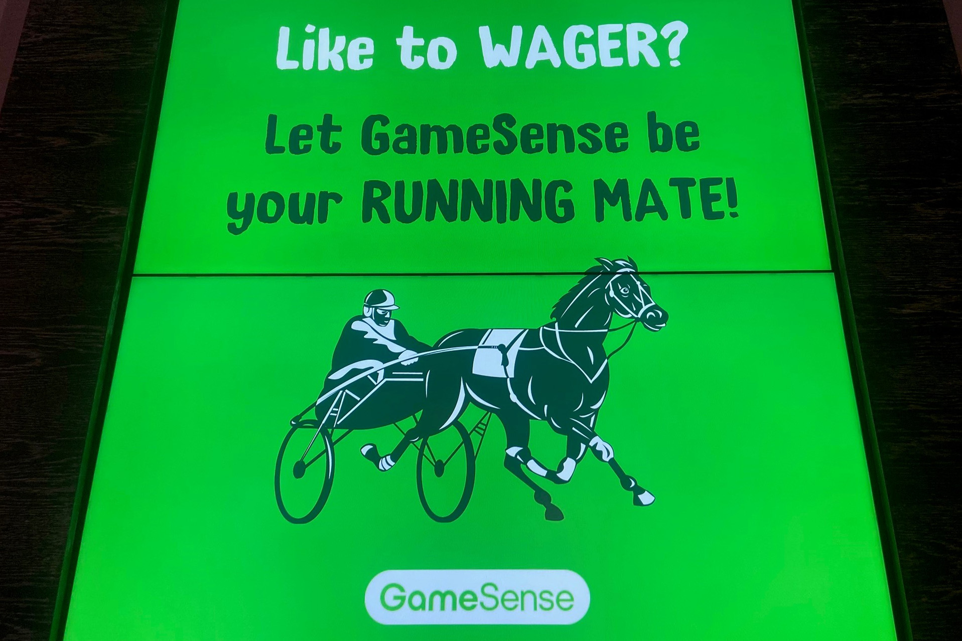 A photo of an ad for GameSense. It reads, "Like to wager? Let GameSense be your running mate."