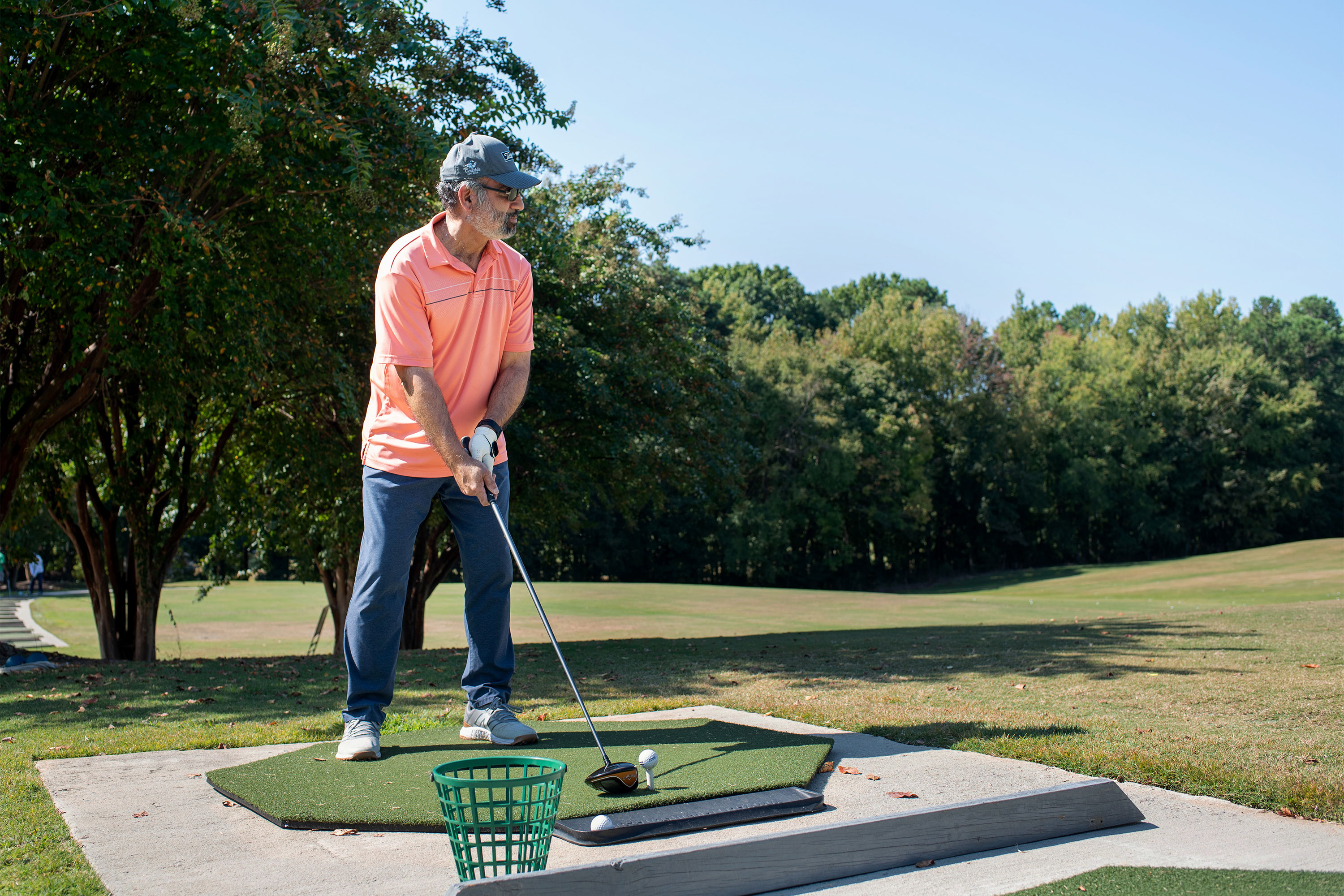 A photo of Jim Washington teeing up a shot at a golf course.