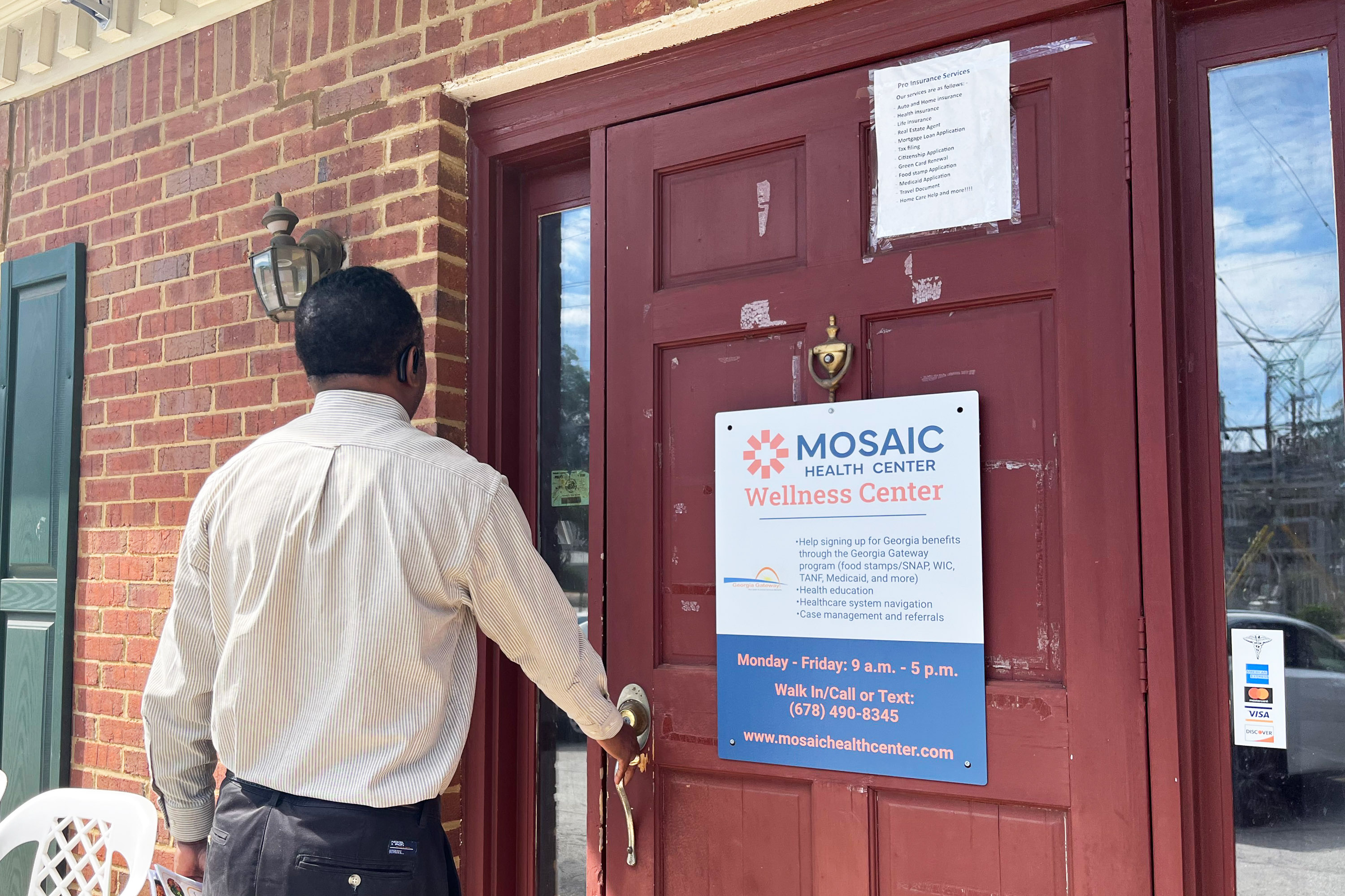 A photo of a Black man seen from behind opening a door showing Mosaic Health Center's logo.