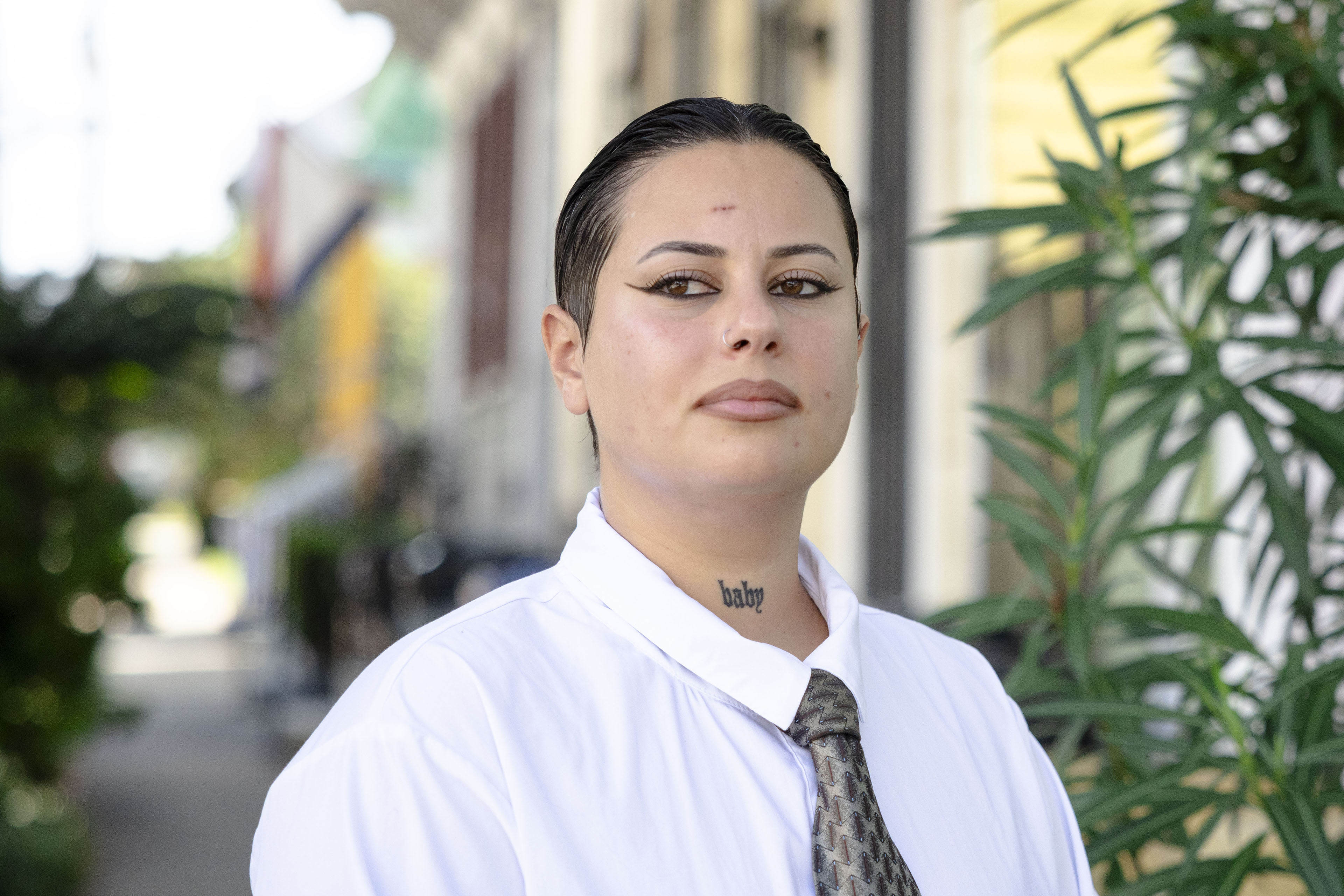 A portrait of a woman wearing a white dress shirt and tie.