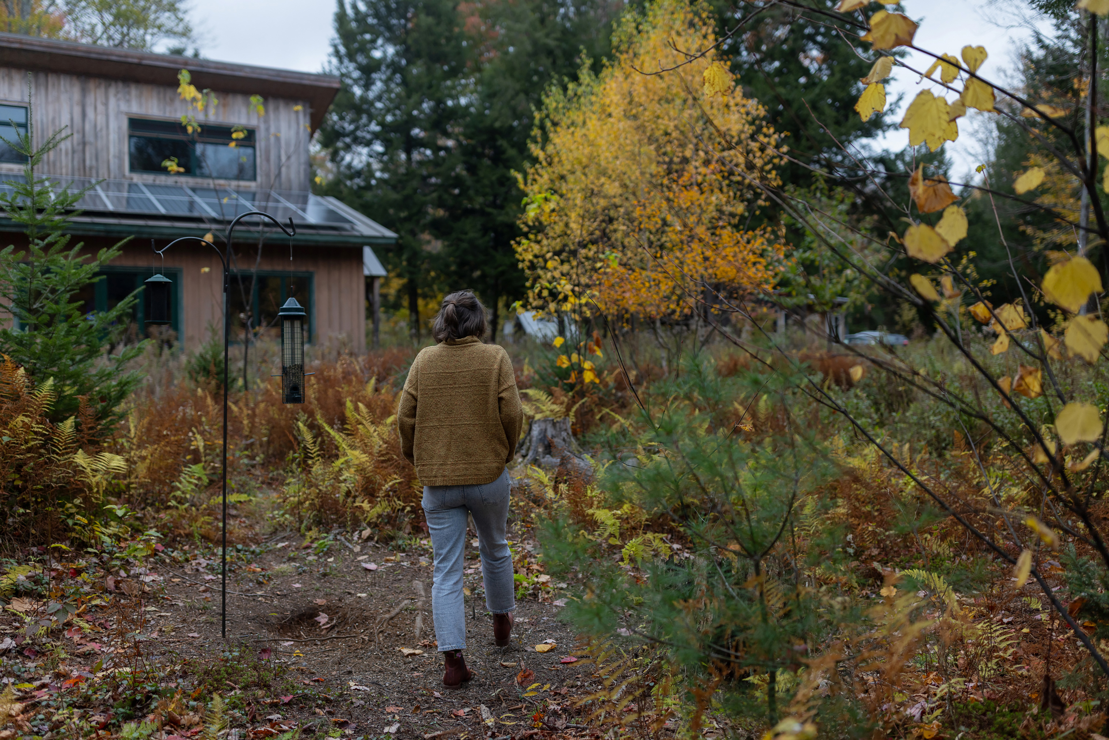 A photo of Leah Kovitch walking to her home from her meadow.