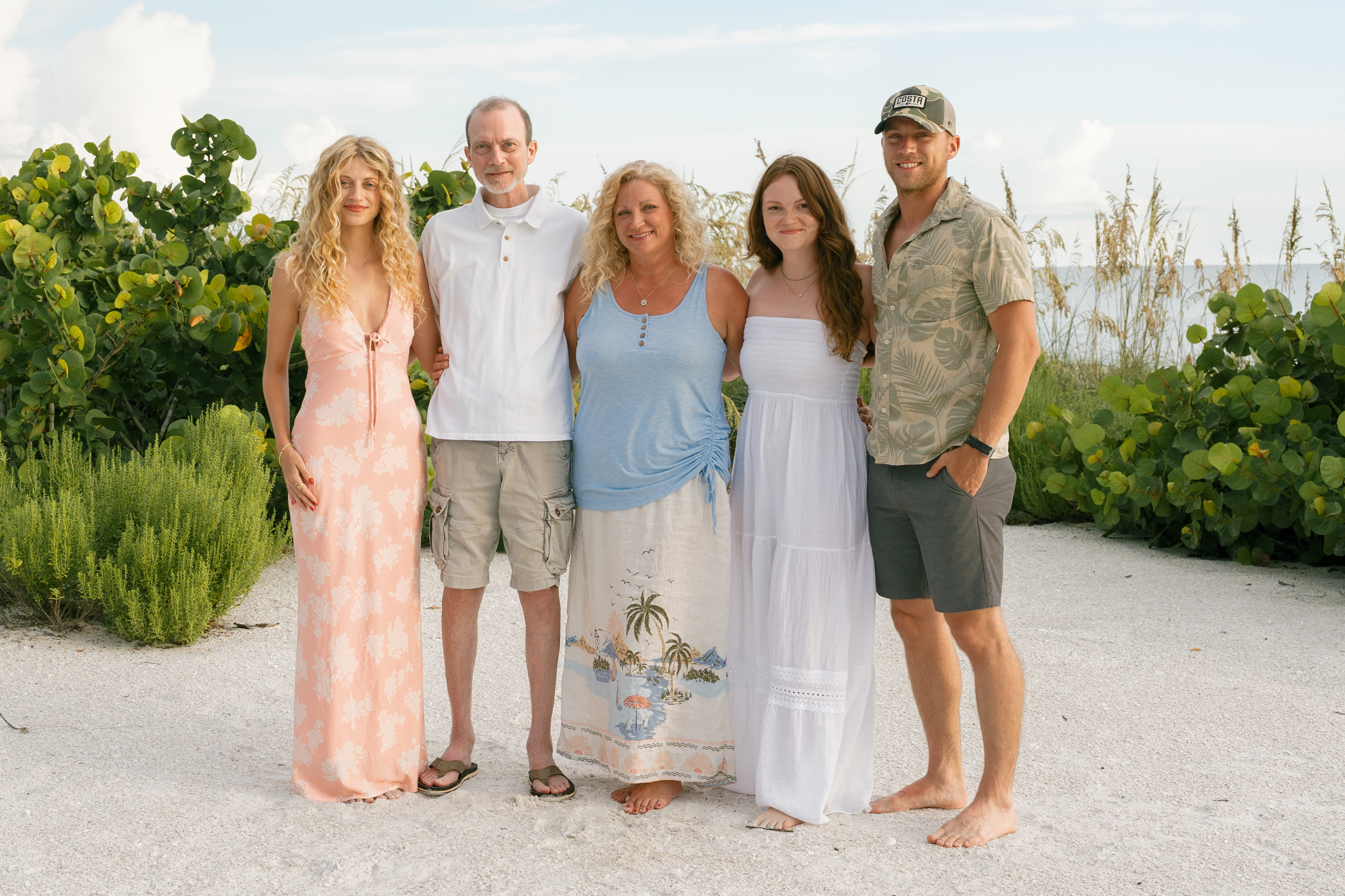 A photo of the Tennant family standing on a beach in Florida.