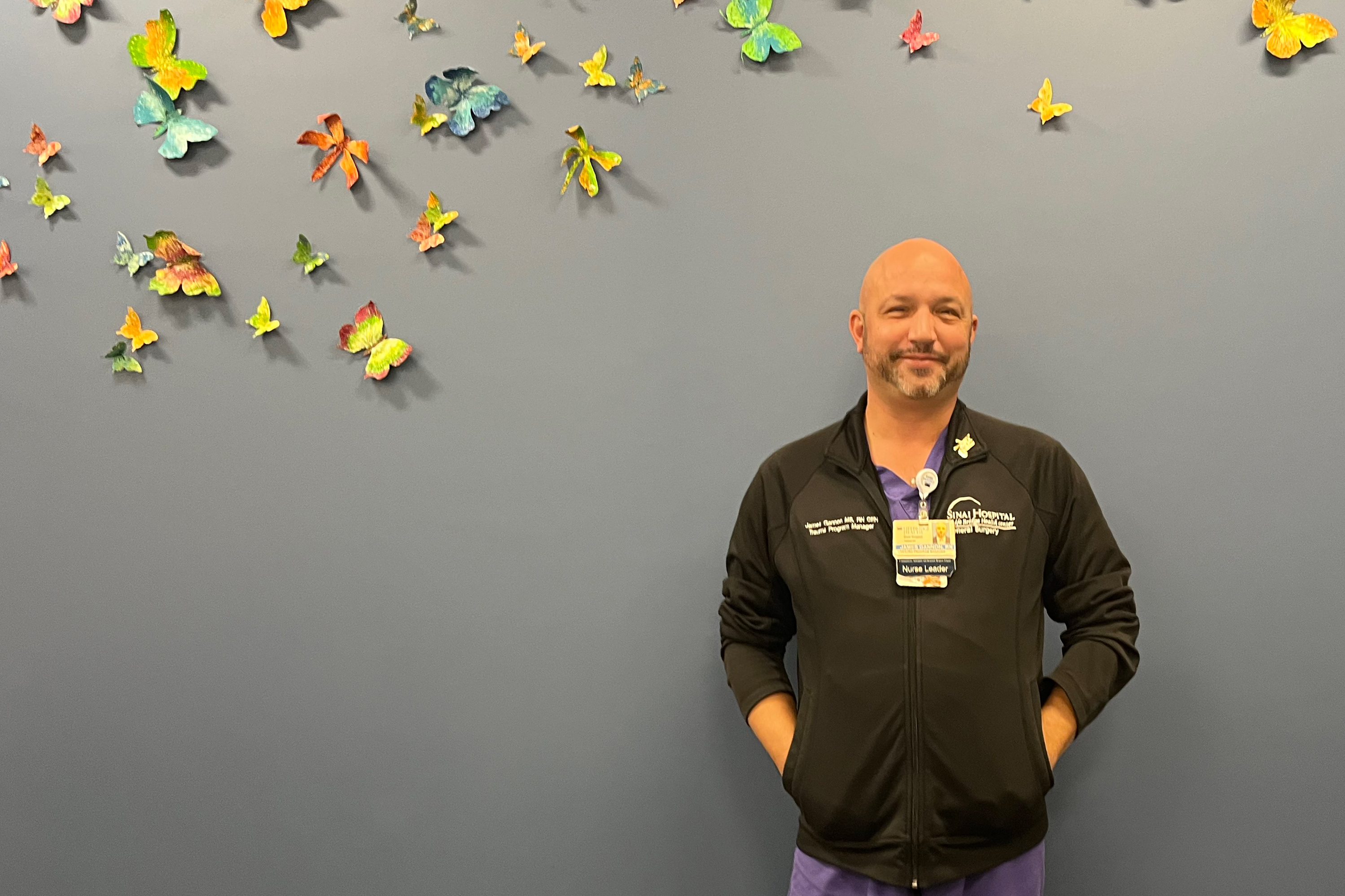 A photo of a man standing indoors.