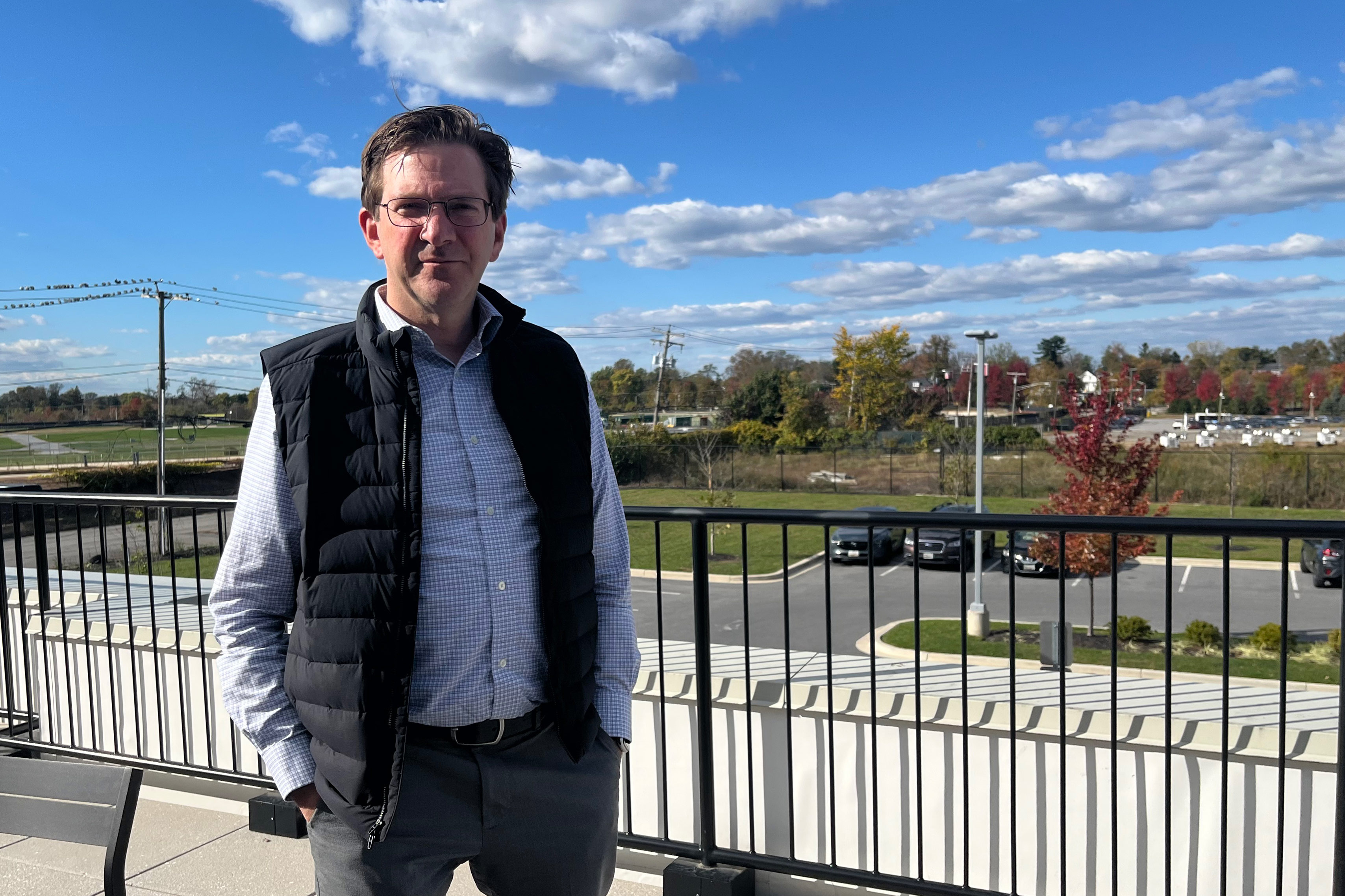 A photo of a man standing outside.