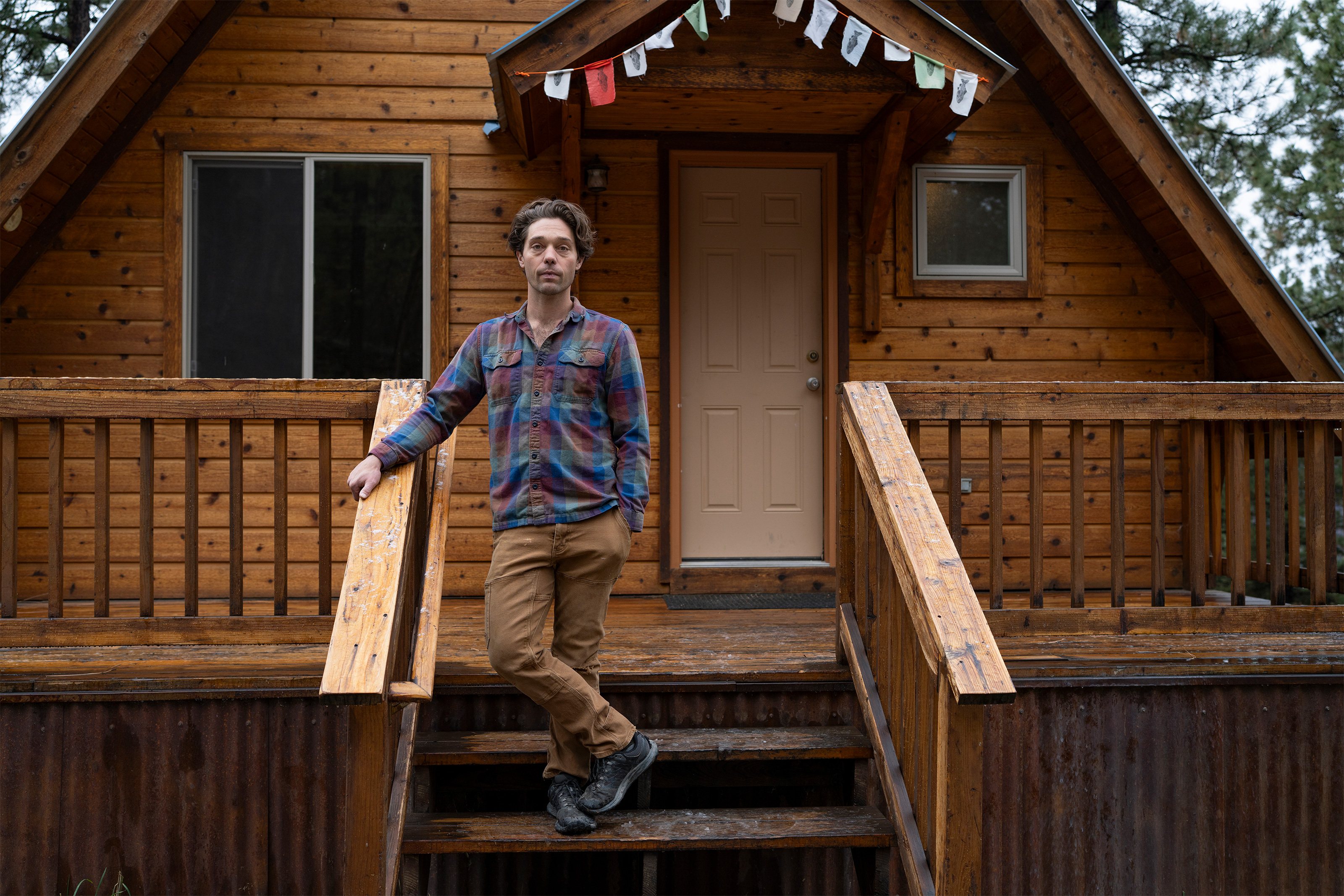 A photo of Maxwell Kruzic standing on steps outside his home.