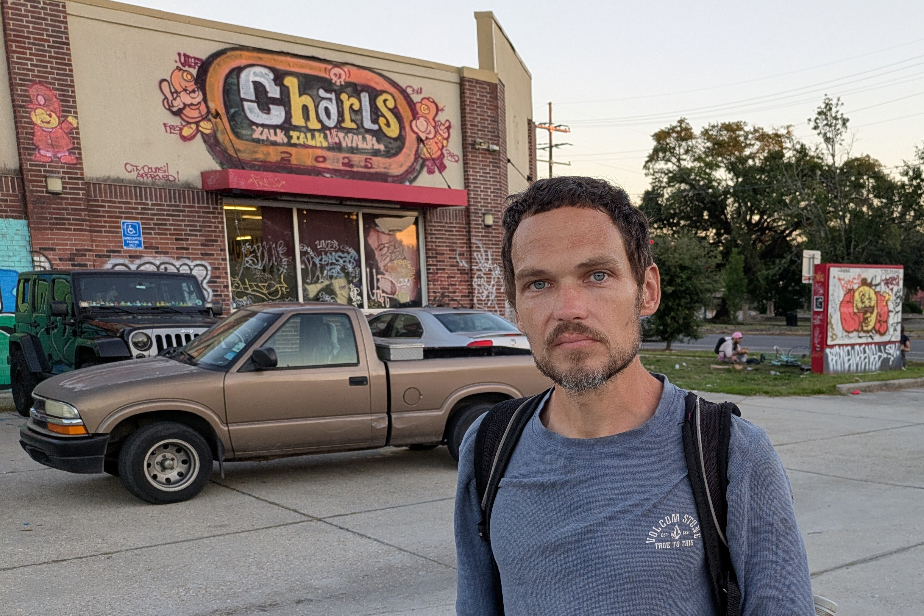 A photo of a man standing outside the Fred Hampton Free Store.